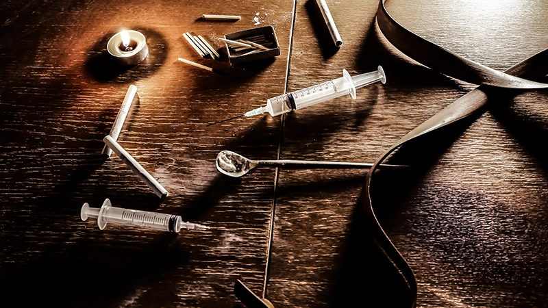 Needle syringe lying on the table and other Needle syringe lying on the table and other drug paraphernalia.