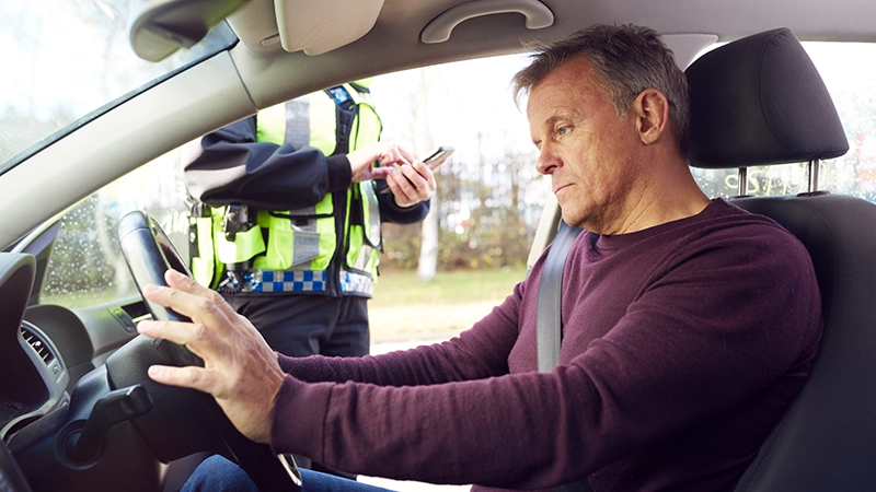 Female police officer ticketing driver.