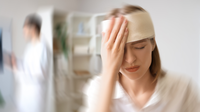 Young woman with brain concussion visiting doctor in clinic