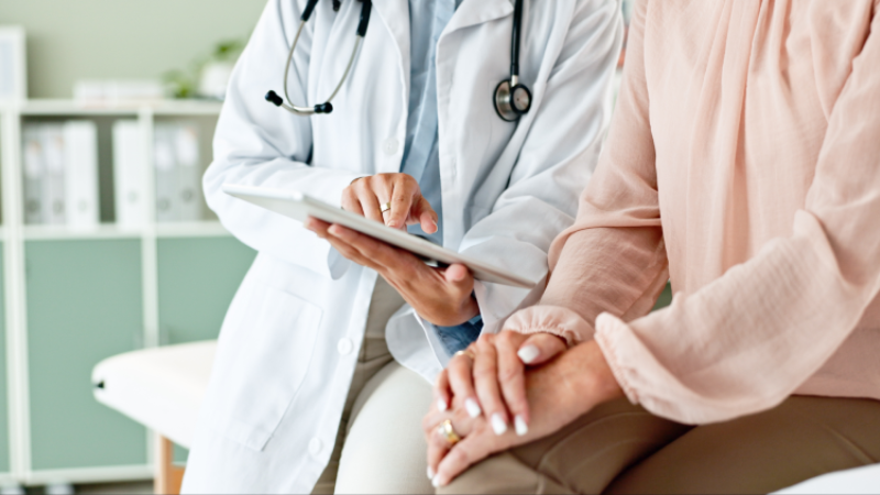 Clinic, tablet and hands of doctor with patient for consulting, medical service and help in hospital. Healthcare, telehealth and people on digital tech for diagnosis, online results and insurance