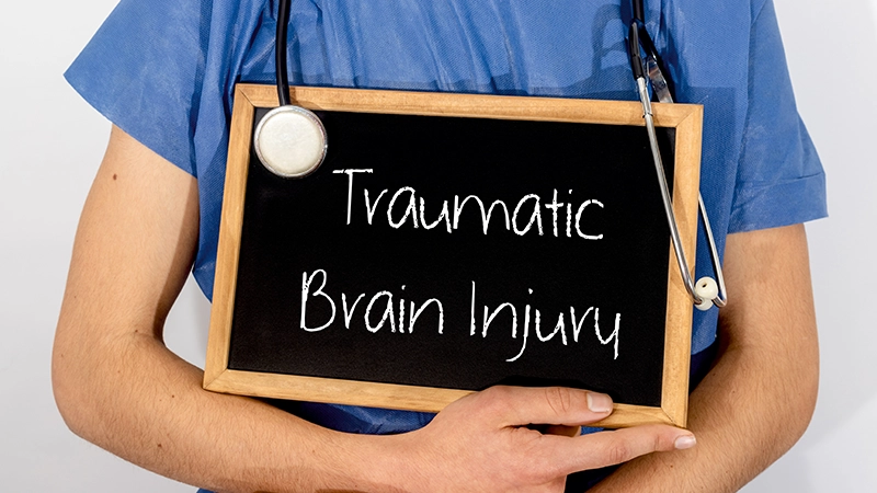 Doctor shows information on blackboard: traumatic brain injury.