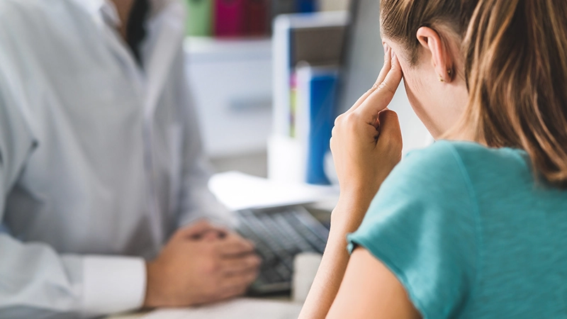 Woman suffering from bad headache or migraine.