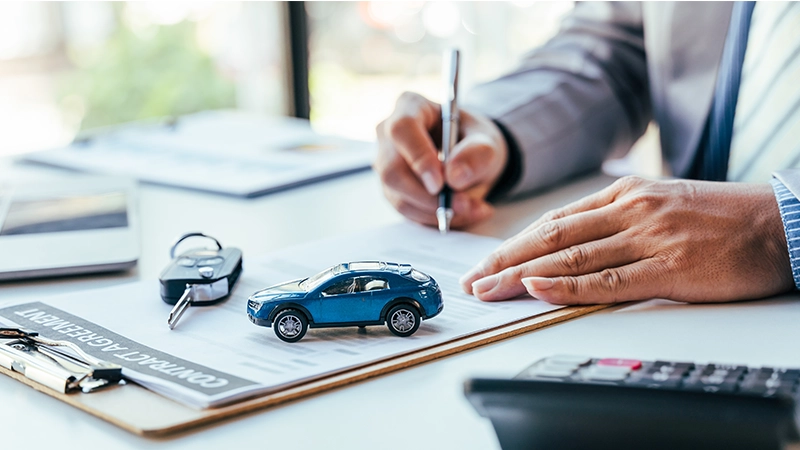 Man signing car insurance document or lease paper.