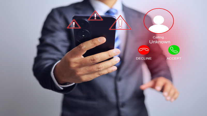 A scammer call to businessman phone and he is deciding accept or decline with warning sign appears on the screen danger warning of anonymous number calling number