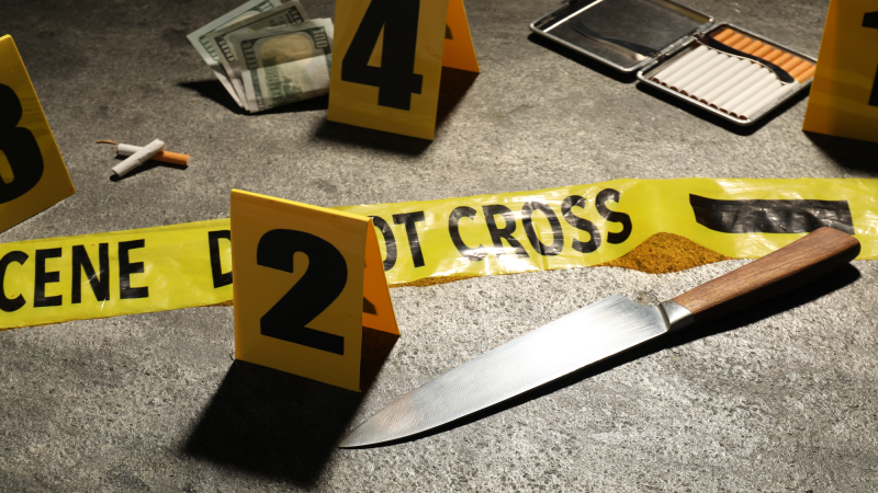 Forensic expertise. Crime scene with evidence, markers and police tape on grey background, closeup